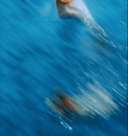 Swimmer moving through blue water